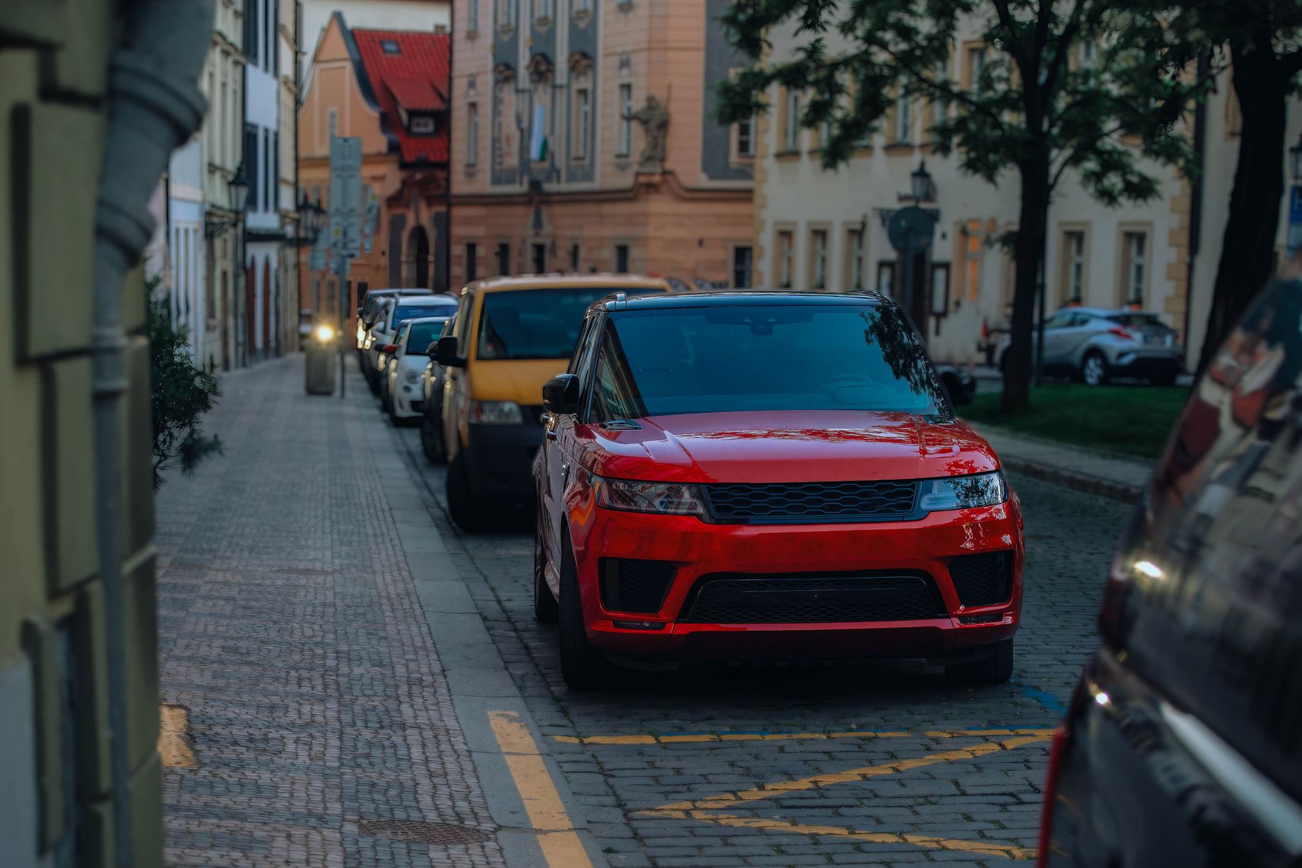 Street view in a city with parked cars, highlighting urban architecture and lifestyle. — 3 Focus Areas in Finding Another Veh