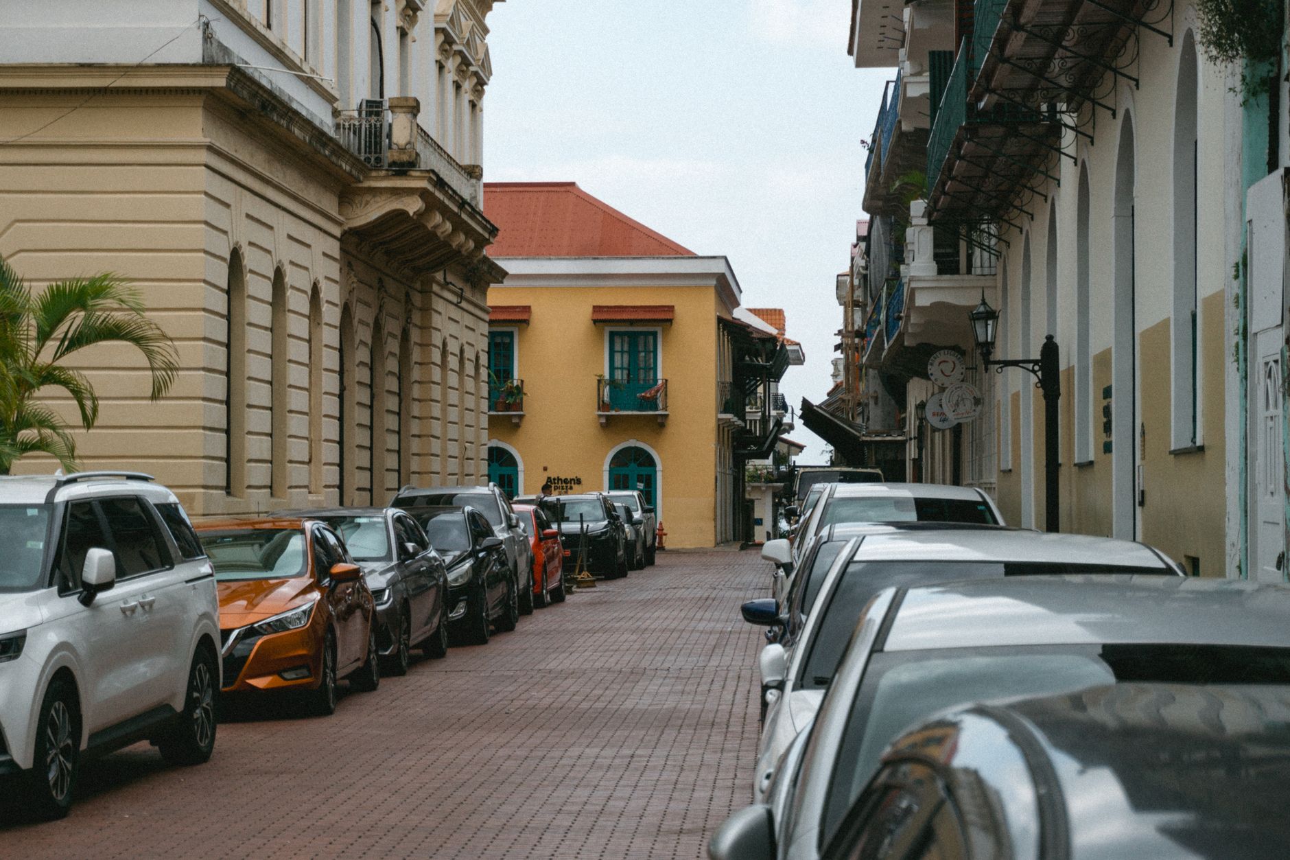Charming street in Panama City with parked cars and colonial architecture under a clear sky. — 5 Reasons Why You Should Buy t