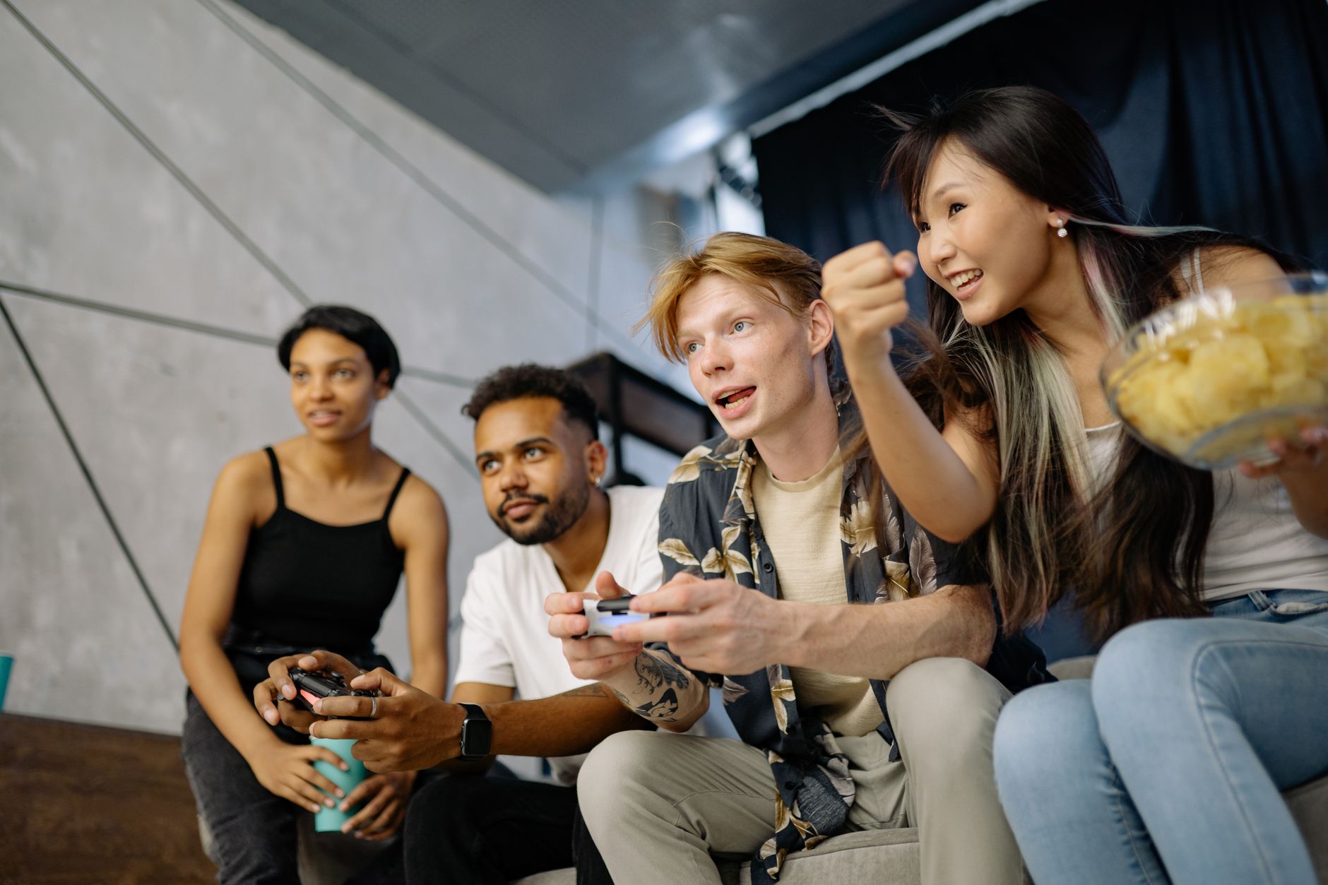Four friends gaming enthusiastically inside a modern home, enjoying a lively moment. — Casino Game RTP Comparison