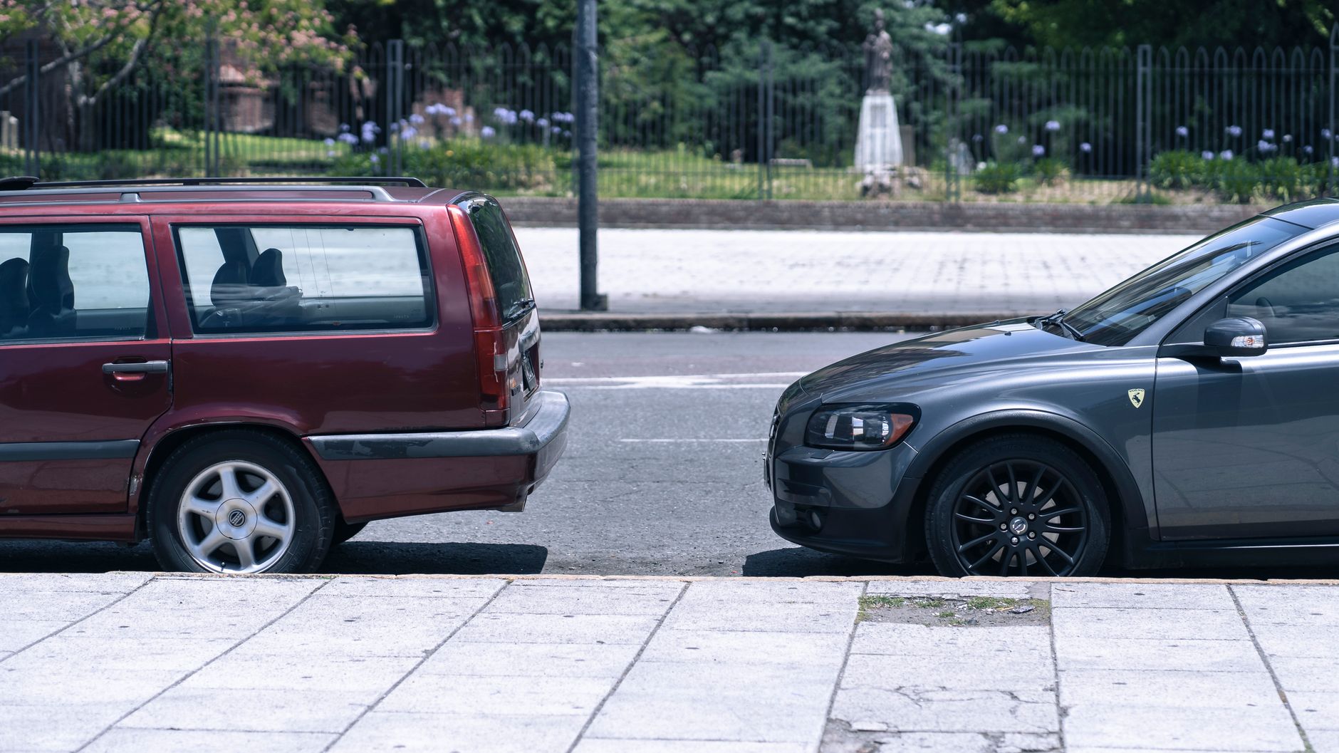 Two parked cars on a sunny street in La Plata, Argentina, showcasing a classic urban cityscape view. — Enter Your Wedding Cer