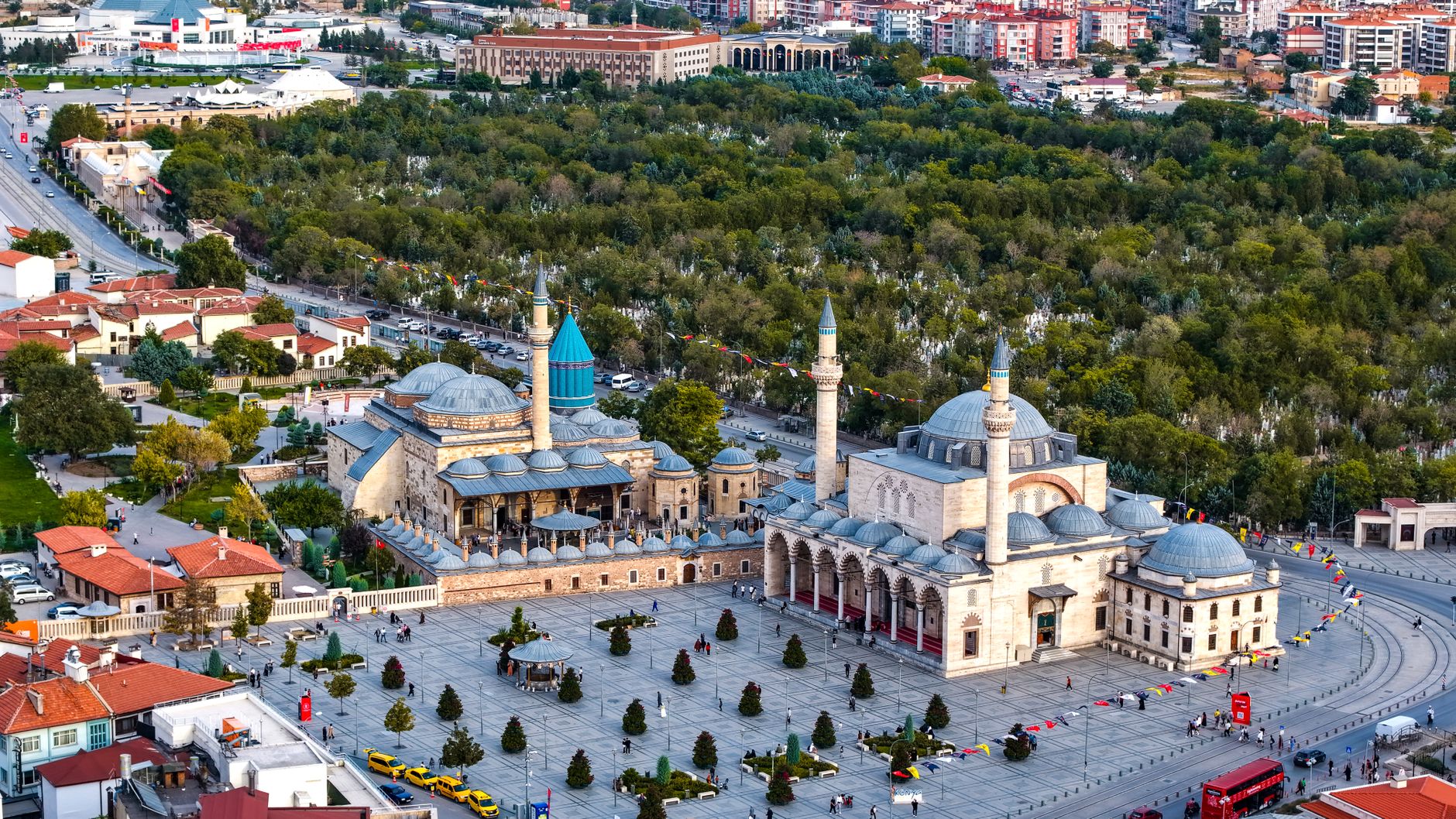 Vibrant aerial view of the iconic Mevlana Museum located in Konya, Türkiye, surrounded by lush greenery. — Feel the Rush of E