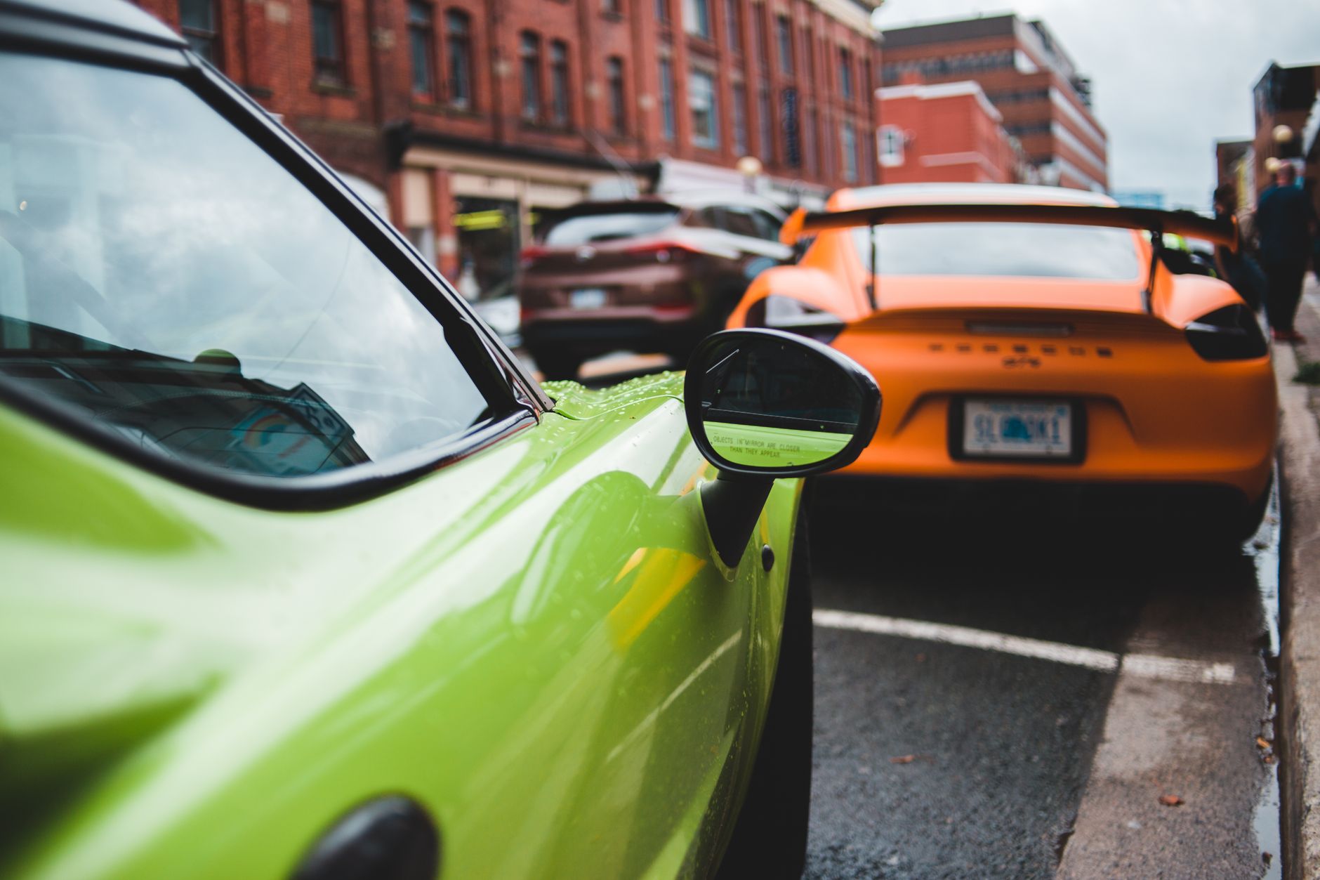 Expensive modern sports car parked on wet asphalt roadway on street in cloudy day — OBD2 Scanner: Things to Know