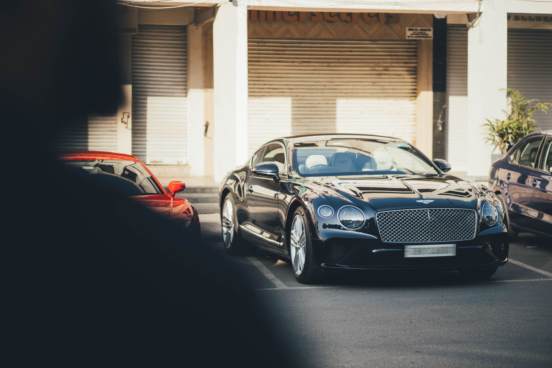 A sleek black Bentley Continental parked in an urban setting in Chandigarh, India. — Searching For The Ideal Used Cars