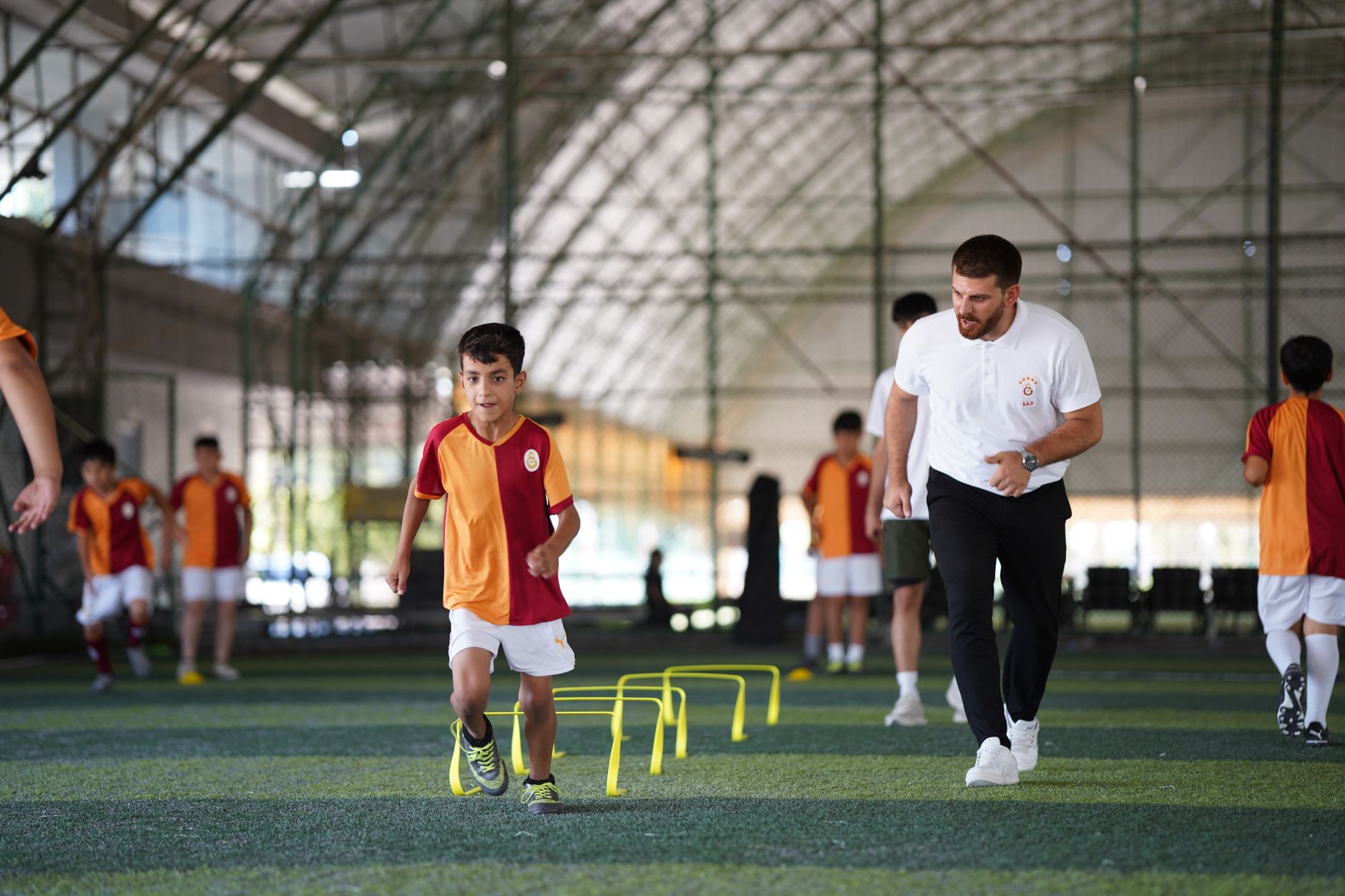 Energetic indoor soccer training with kids and coach, focusing on agility and teamwork. — The Most Comfortable Passenger Vehi