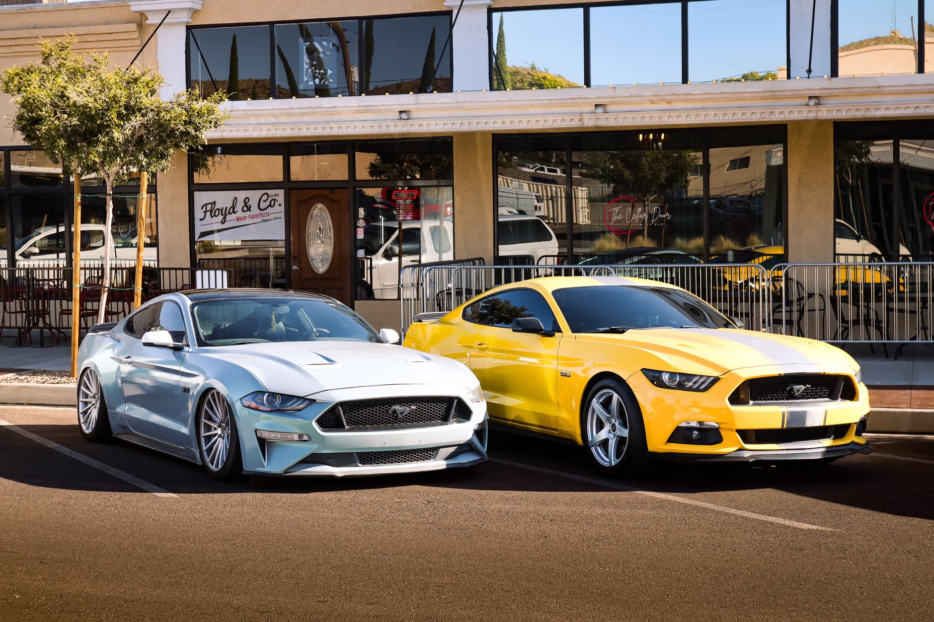 A blue and yellow sports car parked in front of a cafe in an urban area. — Variety of keys for cars that you must know