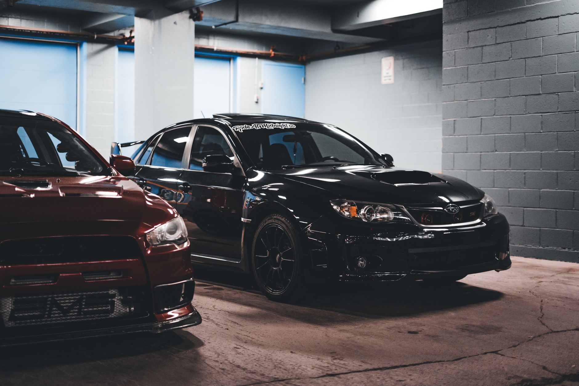 Two sports cars stylishly parked in an urban garage, showcasing modern automotive design. — What Is a Car Pledge: Some Intere
