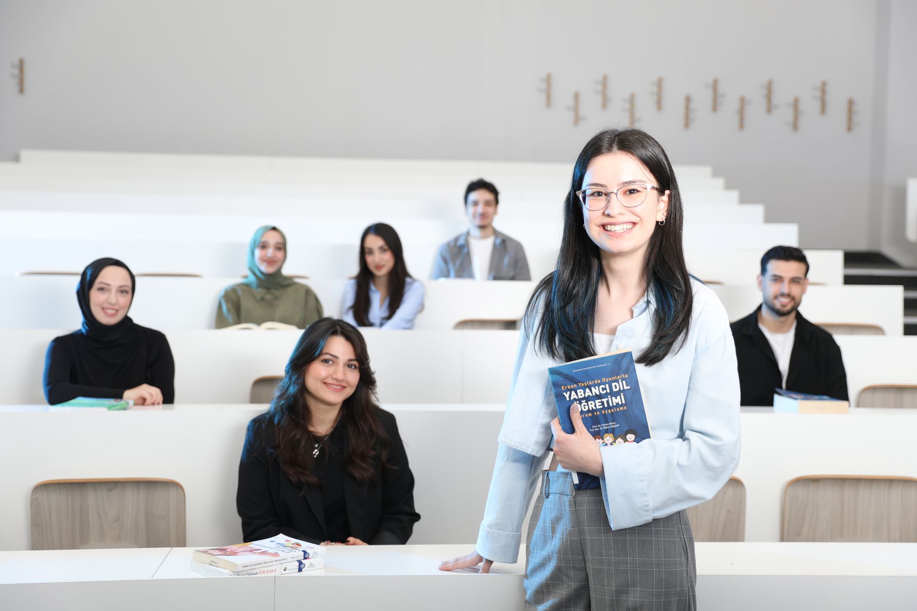 Group of diverse university students in a bright lecture hall, studying language education. — What Is the Minimum Deposit on
