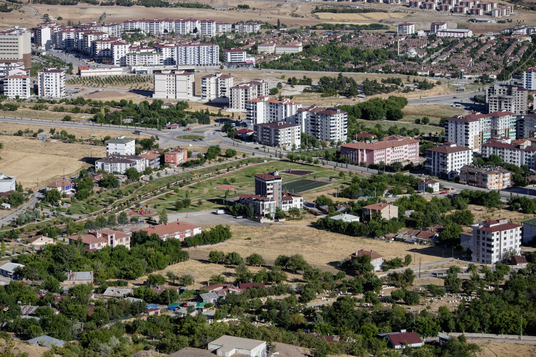 Aerial cityscape of Elâzığ, Türkiye showcasing apartments and greenery in summer. — What Makes Tiranga App Different From Win