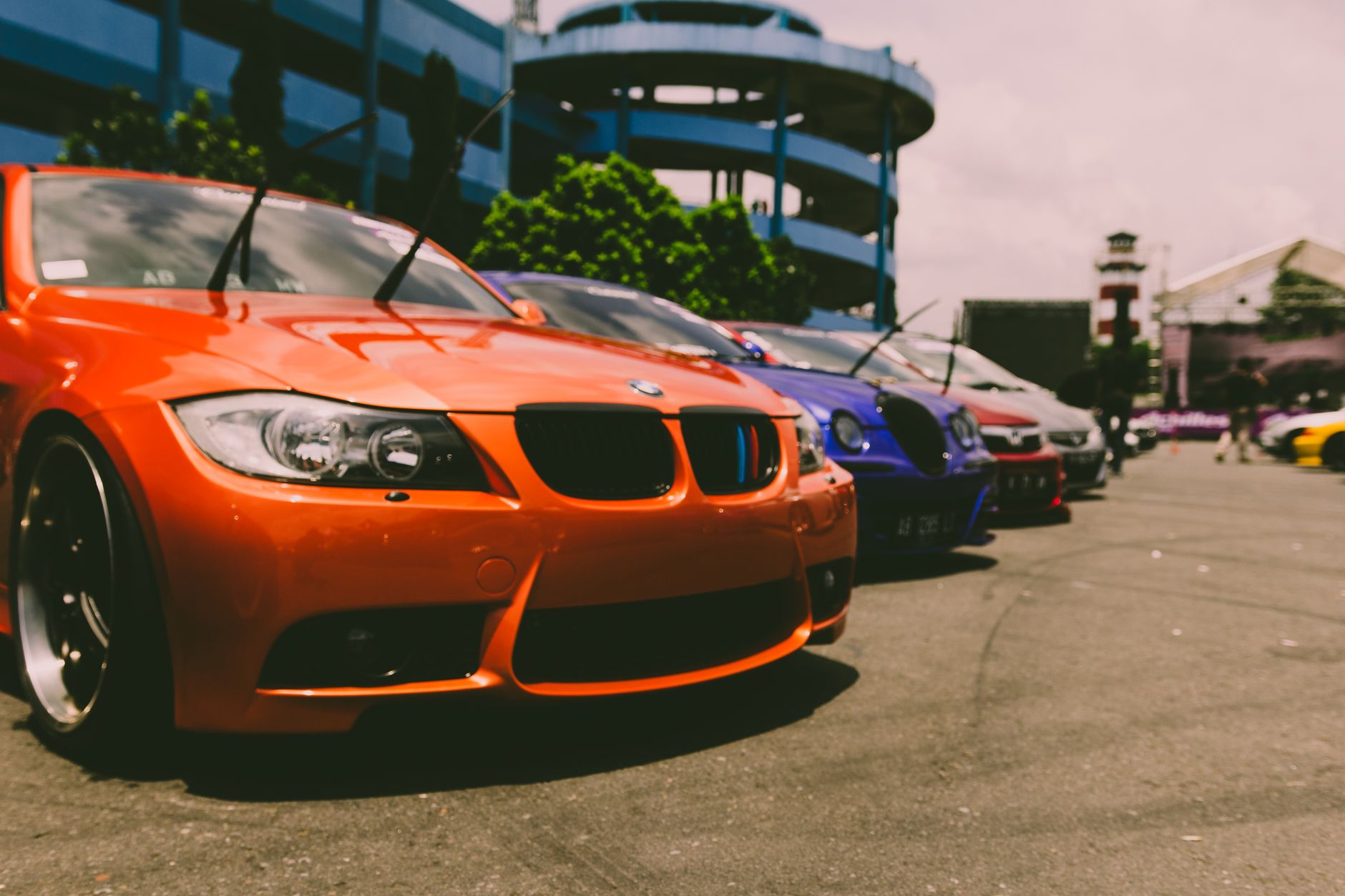 Close-up of vibrant sports cars parked outdoors, showcasing custom modifications and sleek designs. — Why Car HUD Display is
